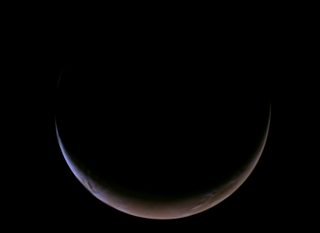 A slender crescent of Mars against black space.